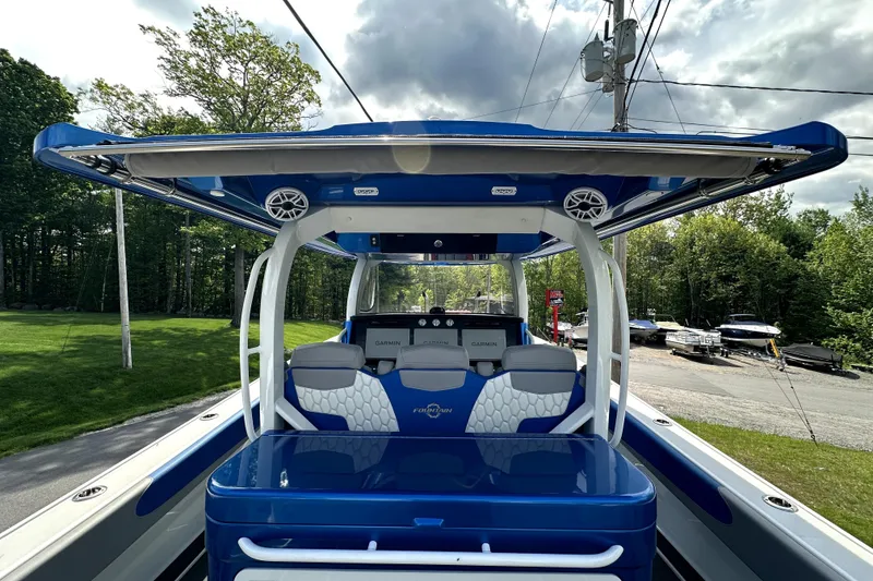 Slide: The Image of 2023 Fountain 43 NX boat with sleek blue design and advanced Garmin navigation system. - 18