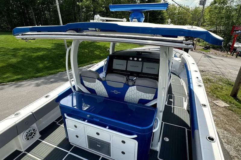 Slide: The Image of 2023 Fountain 43 NX boat with blue and white interior, featuring Garmin navigation displays. - 19