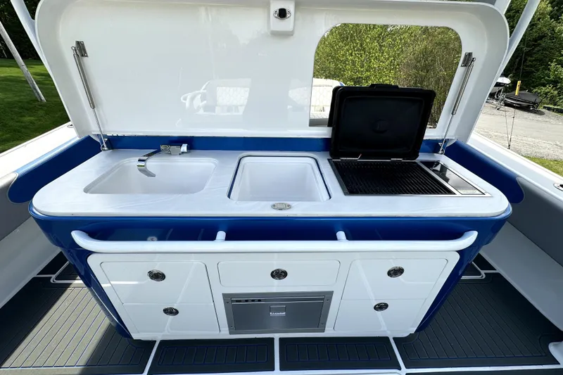 Slide: The Image of Outdoor kitchen setup on 2023 Fountain 43 NX boat with sink and grill. - 21