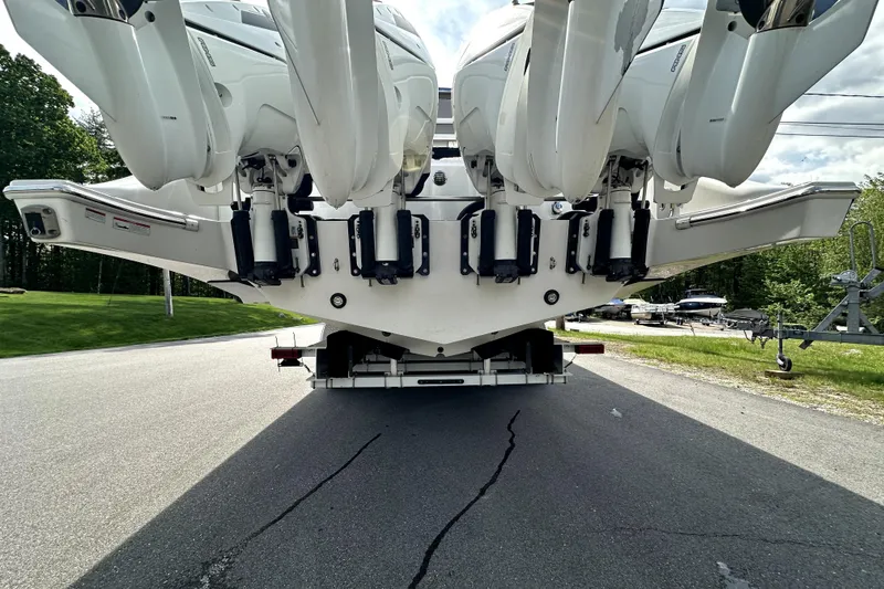 Slide: The Image of Rear view of 2023 Fountain 43 NX boat with multiple outboard engines on a trailer. - 24