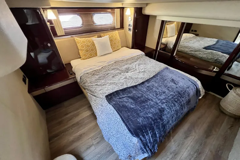 Slide: The Image of Luxurious bedroom interior of 2007 Sea Ray 58 Sedan Bridge yacht with cozy bedding. - 103