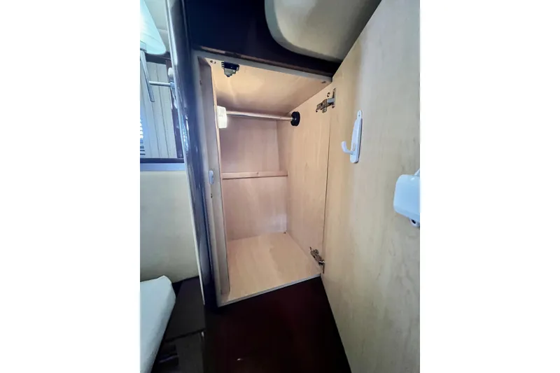 Slide: The Image of Open wooden cabinet inside 2007 Sea Ray 58 Sedan Bridge yacht interior. - 105