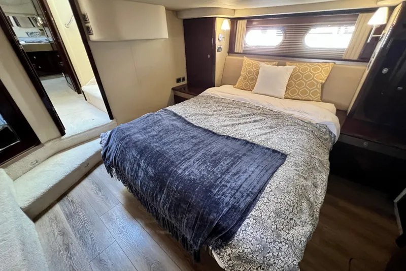 Slide: The Image of Luxurious bedroom interior of 2007 Sea Ray 58 Sedan Bridge yacht with cozy bedding. - 106