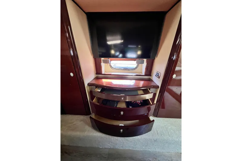 Slide: The Image of Luxurious interior of 2007 Sea Ray 58 Sedan Bridge with TV and storage drawers. - 108