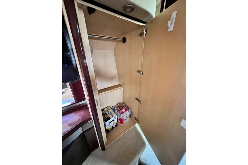 Slide: The Image of Open cabinet in 2007 Sea Ray 58 Sedan Bridge yacht, storing beverages and supplies. - 110