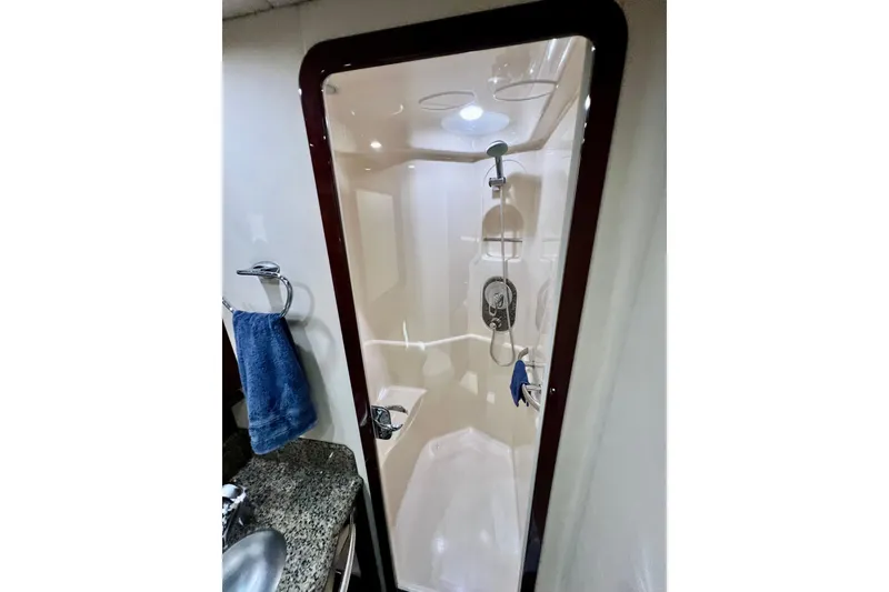 Slide: The Image of Shower area in 2007 Sea Ray 58 Sedan Bridge yacht, featuring modern fixtures and granite countertop. - 113