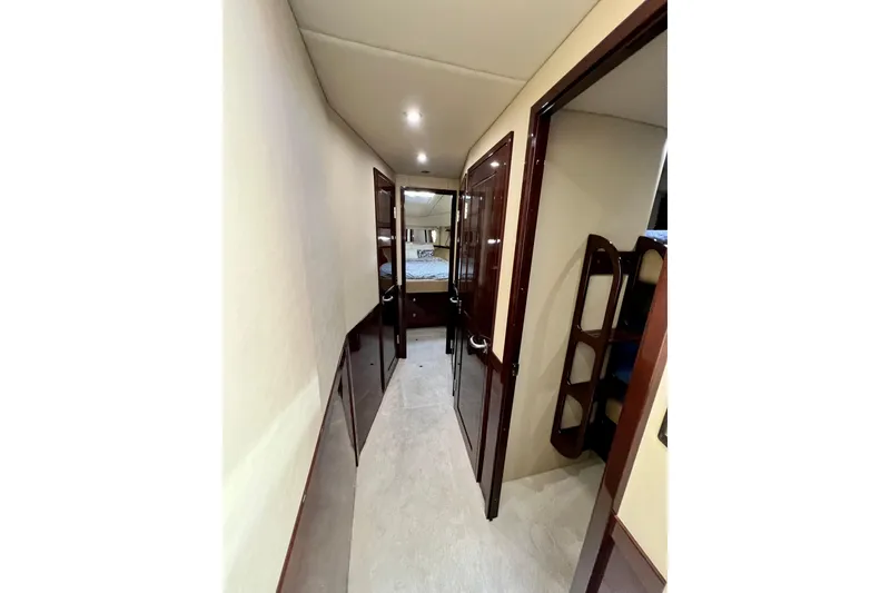 Slide: The Image of Hallway inside 2007 Sea Ray 58 Sedan Bridge yacht, featuring elegant wood finishes and modern lighting. - 115