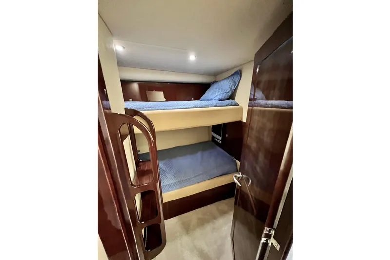 Slide: The Image of 2007 Sea Ray 58 Sedan Bridge cabin with cozy bunk beds and wooden interior. - 116