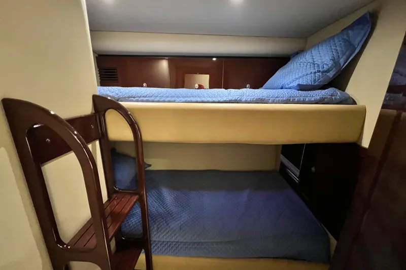 Slide: The Image of Bunk beds with blue bedding in 2007 Sea Ray 58 Sedan Bridge yacht cabin. - 117