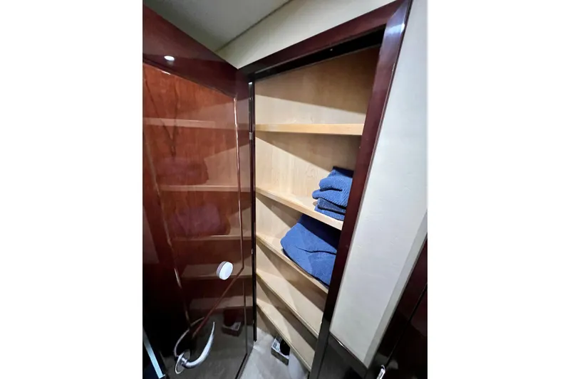 Slide: The Image of Storage shelves with blue towels inside 2007 Sea Ray 58 Sedan Bridge yacht. - 121