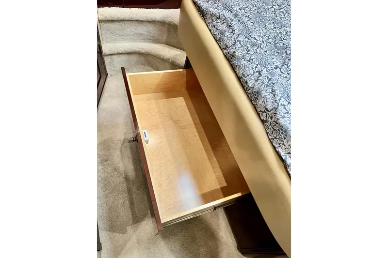 Slide: The Image of Open wooden drawer under bed in 2007 Sea Ray 58 Sedan Bridge yacht interior. - 124