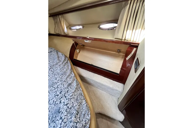 Slide: The Image of Interior cabin of 2007 Sea Ray 58 Sedan Bridge yacht with storage and porthole. - 125