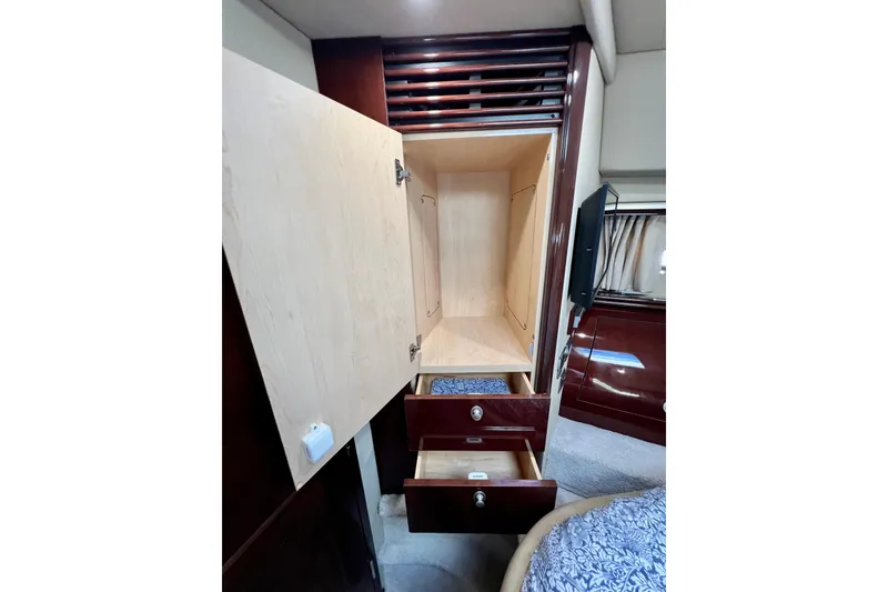 Slide: The Image of Interior storage of 2007 Sea Ray 58 Sedan Bridge yacht, featuring open cabinet and drawers. - 129