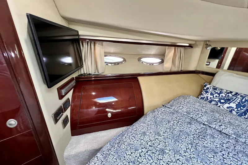 Slide: The Image of Luxurious cabin interior of 2007 Sea Ray 58 Sedan Bridge with TV and elegant bedding. - 130