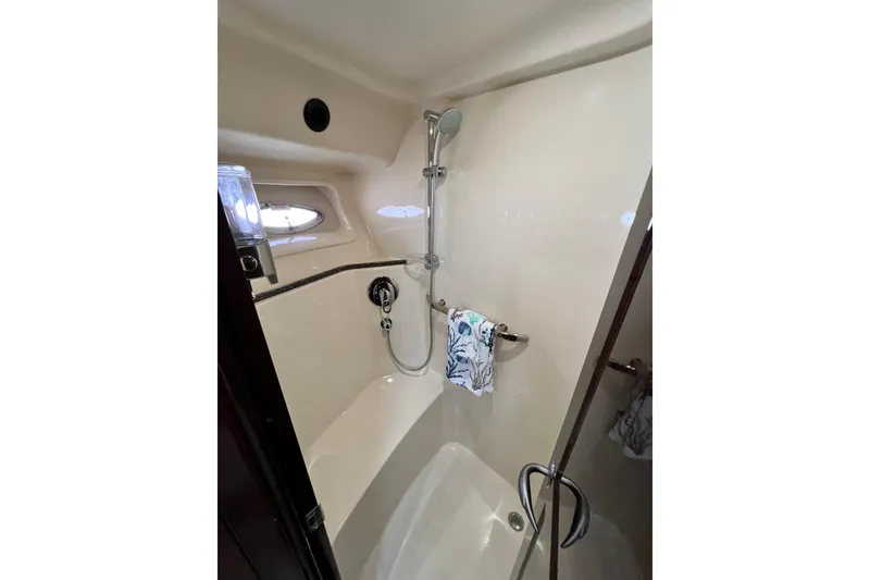 Slide: The Image of Shower area in 2007 Sea Ray 58 Sedan Bridge yacht, featuring modern fixtures and porthole window. - 135