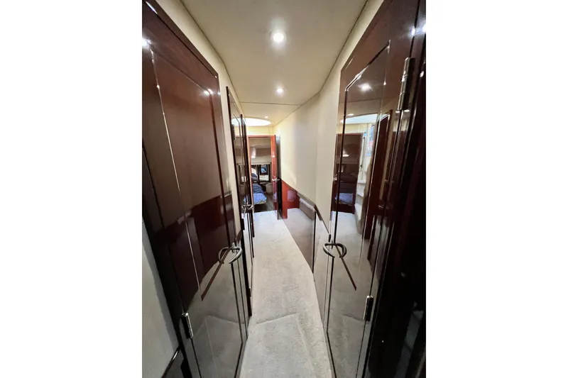 Slide: The Image of Interior hallway of 2007 Sea Ray 58 Sedan Bridge yacht with polished wood doors. - 136
