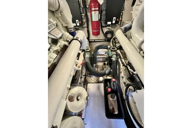 Slide: The Image of Engine room of 2007 Sea Ray 58 Sedan Bridge with visible fire extinguisher and mechanical components. - 140