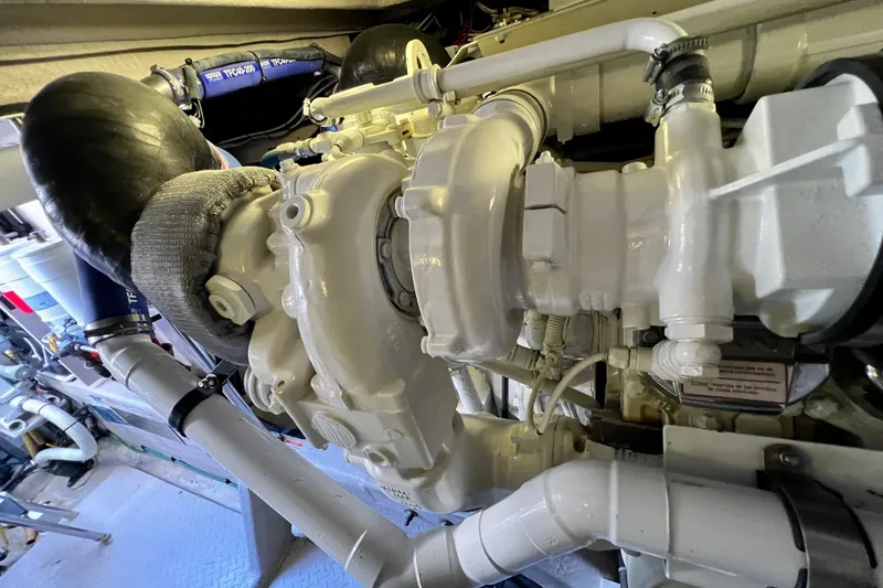 Slide: The Image of Engine compartment of a 2007 Sea Ray 58 Sedan Bridge yacht, showcasing mechanical components. - 142