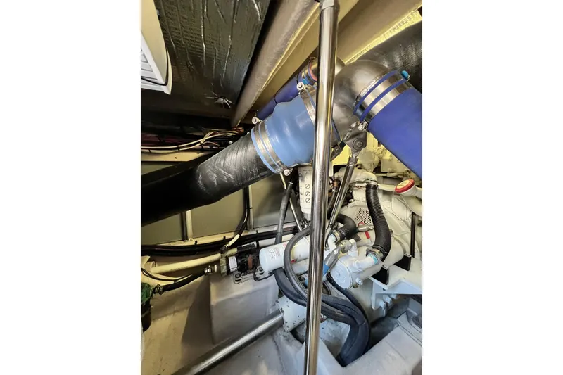 Slide: The Image of Engine room of 2007 Sea Ray 58 Sedan Bridge with visible pipes and components. - 143
