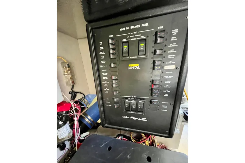 Slide: The Image of Electrical panel of a 2007 Sea Ray 58 Sedan Bridge yacht, featuring various switches and wiring. - 144