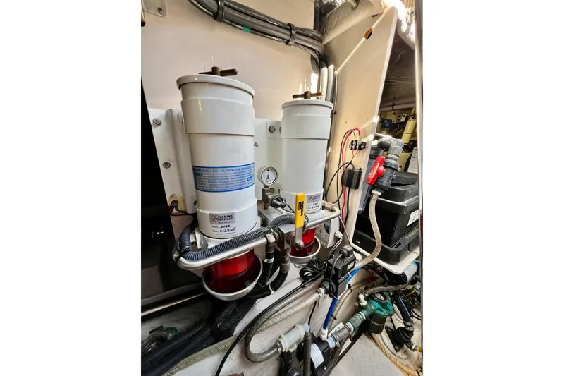 Slide: The Image of Engine room of 2007 Sea Ray 58 Sedan Bridge with fuel filters and wiring. - 145