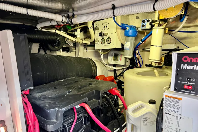 Slide: The Image of Engine room of a 2007 Sea Ray 58 Sedan Bridge with marine equipment and wiring. - 146