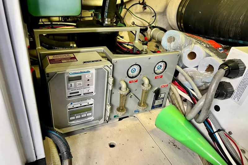 Slide: The Image of Engine room of 2007 Sea Ray 58 Sedan Bridge with water quality monitor and gauges. - 148