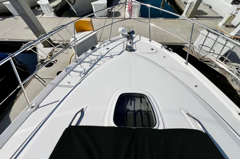 Slide: The Image of 2007 Sea Ray 58 Sedan Bridge yacht deck with railing and hatch, docked at marina. - 19