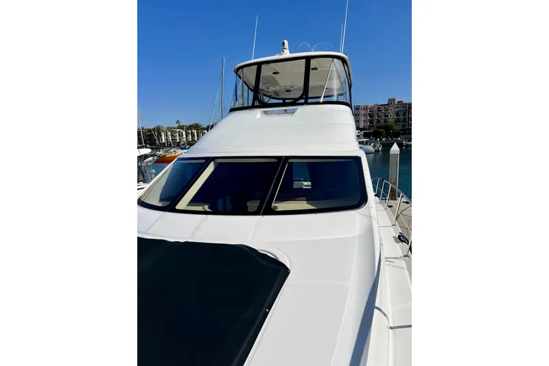 Slide: The Image of 2007 Sea Ray 58 Sedan Bridge yacht docked at marina under clear blue sky. - 23