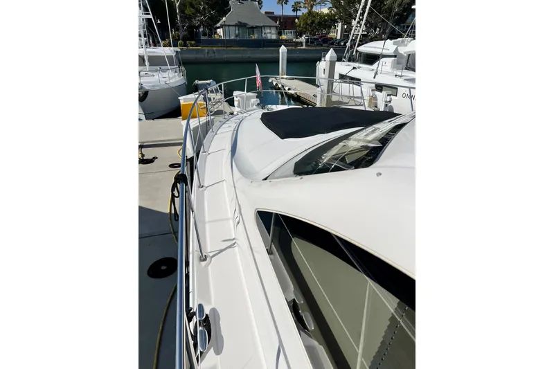 Slide: The Image of 2007 Sea Ray 58 Sedan Bridge yacht docked at marina, side view. - 24