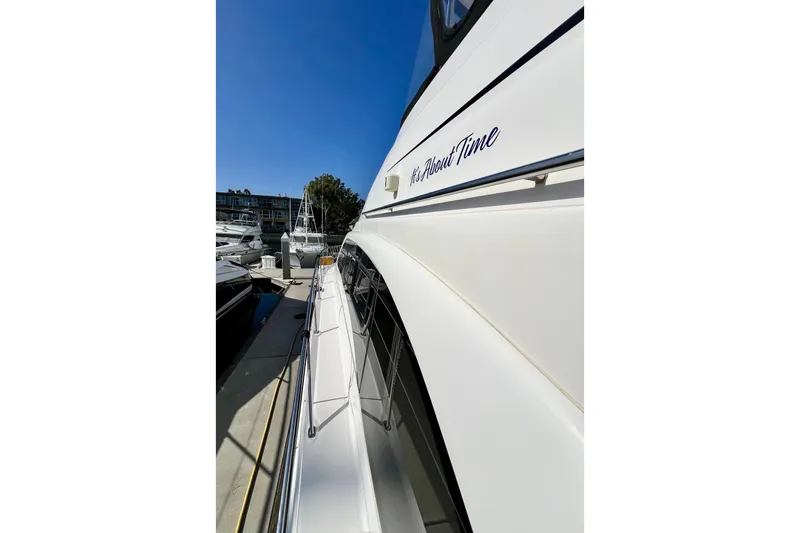 Slide: The Image of 2007 Sea Ray 58 Sedan Bridge yacht docked, side view with clear blue sky. - 26