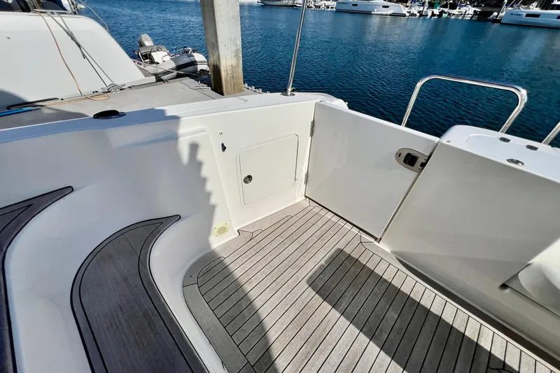 Slide: The Image of 2007 Sea Ray 58 Sedan Bridge yacht deck with open door, docked at marina. - 34