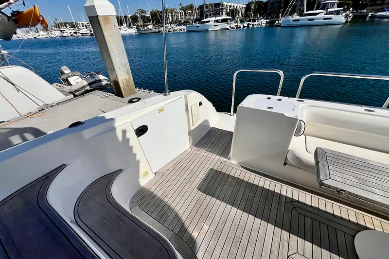 Slide: The Image of 2007 Sea Ray 58 Sedan Bridge yacht deck with marina view, featuring sleek design and seating area. - 35