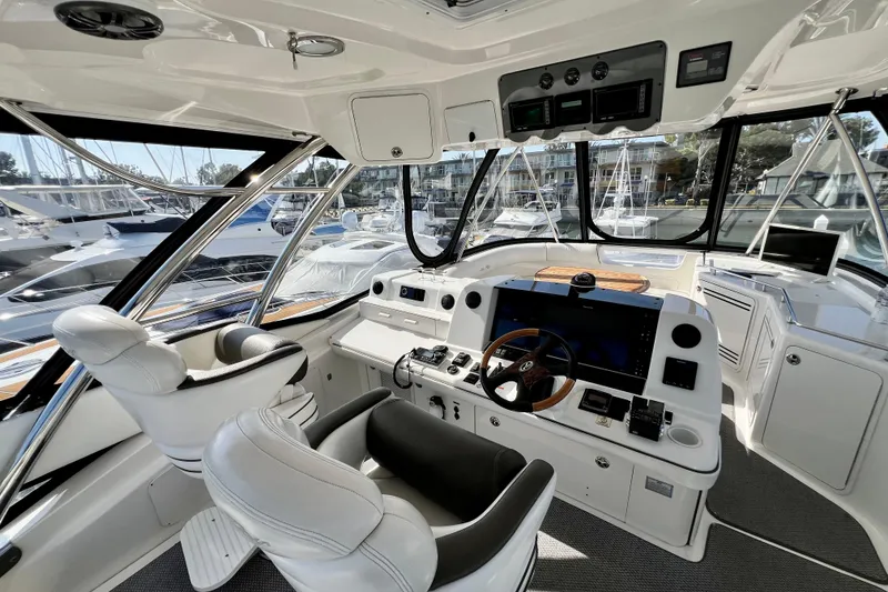 Slide: The Image of Luxurious helm of 2007 Sea Ray 58 Sedan Bridge yacht with modern controls and seating. - 45