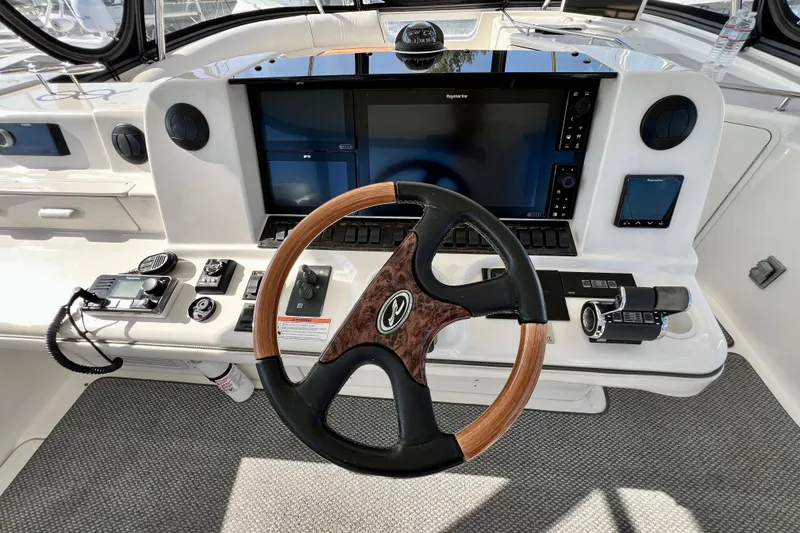 Slide: The Image of 2007 Sea Ray 58 Sedan Bridge helm with steering wheel and navigation controls. - 46