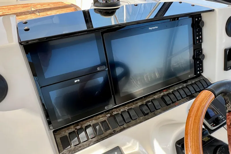 Slide: The Image of Control panel of a 2007 Sea Ray 58 Sedan Bridge yacht with navigation screens. - 47