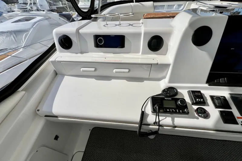 Slide: The Image of 2007 Sea Ray 58 Sedan Bridge helm with navigation controls and communication equipment. - 53