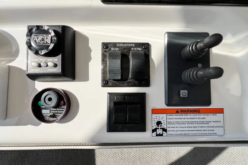Slide: The Image of Control panel of a 2007 Sea Ray 58 Sedan Bridge with thrusters and warning label. - 54