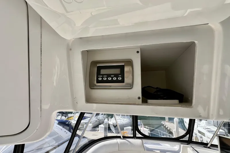 Slide: The Image of Control panel inside 2007 Sea Ray 58 Sedan Bridge yacht, with marina view. - 58