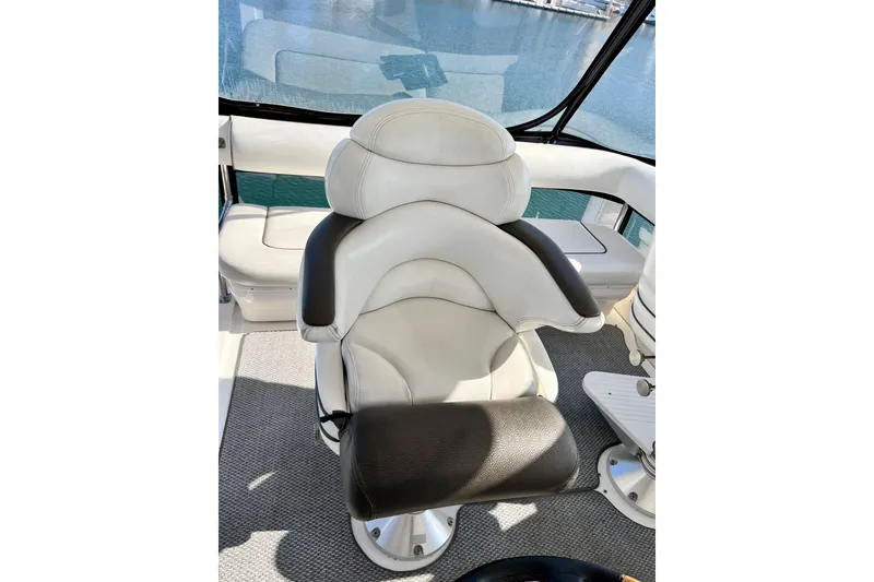 Slide: The Image of Captain's chair on 2007 Sea Ray 58 Sedan Bridge yacht, overlooking marina waters. - 62