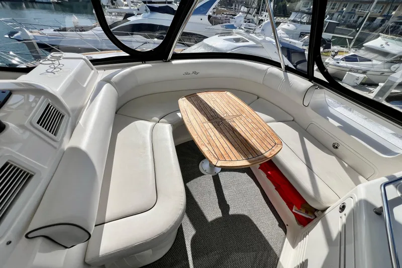 Slide: The Image of Luxurious interior of 2007 Sea Ray 58 Sedan Bridge yacht with elegant seating and wooden table. - 66