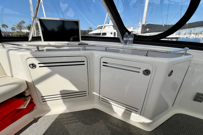 Slide: The Image of Interior view of 2007 Sea Ray 58 Sedan Bridge yacht with cabinets and a monitor. - 67