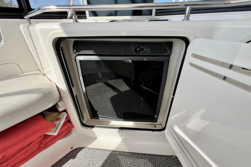 Slide: The Image of 2007 Sea Ray 58 Sedan Bridge interior with built-in mini fridge and seating area. - 69