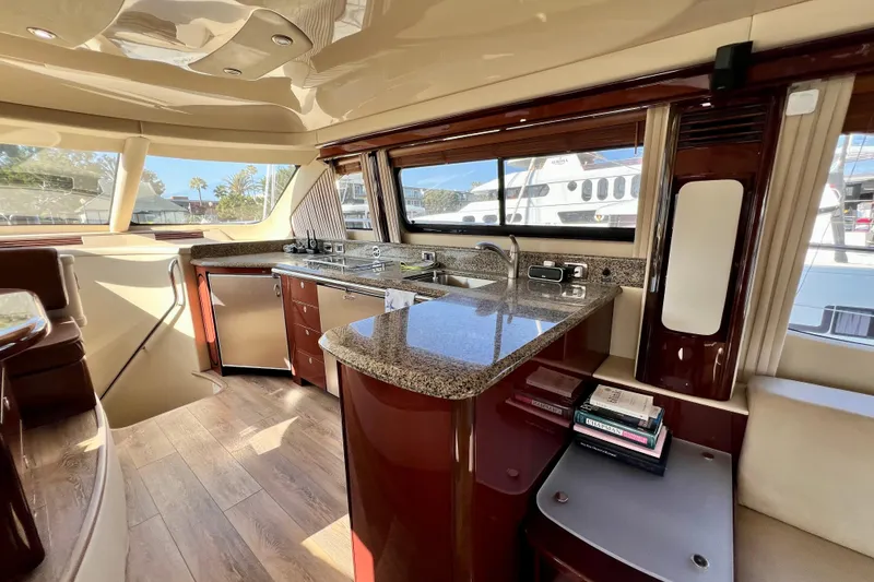 Slide: The Image of Luxurious 2007 Sea Ray 58 Sedan Bridge yacht interior with modern kitchen and elegant wood finishes. - 73