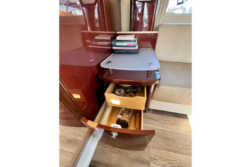 Slide: The Image of Interior of 2007 Sea Ray 58 Sedan Bridge with books and open drawer. - 77