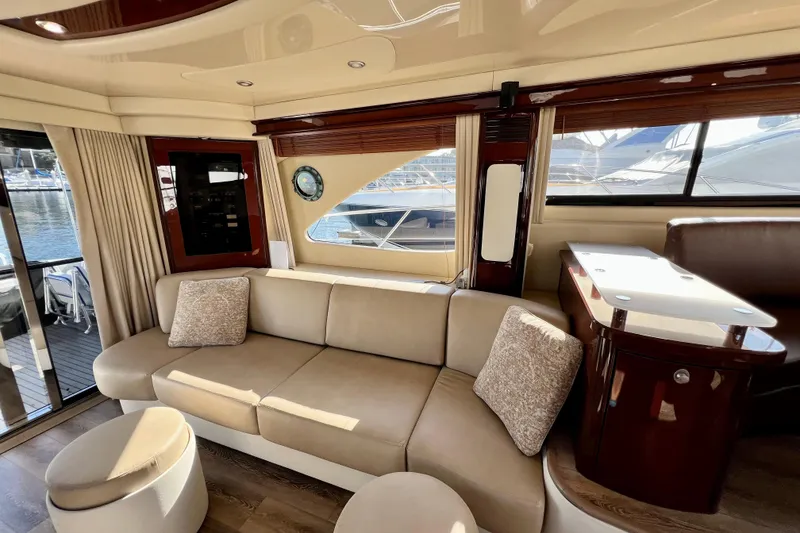 Slide: The Image of Luxurious interior of 2007 Sea Ray 58 Sedan Bridge yacht with elegant seating and wood accents. - 80