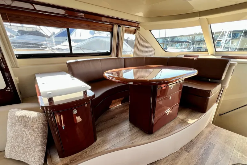 Slide: The Image of Luxurious interior of 2007 Sea Ray 58 Sedan Bridge yacht with elegant seating and table. - 83