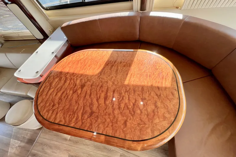 Slide: The Image of Luxurious interior of 2007 Sea Ray 58 Sedan Bridge with elegant wood table and plush seating. - 84