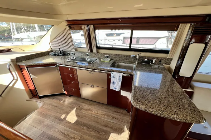 Slide: The Image of Luxurious kitchen interior of 2007 Sea Ray 58 Sedan Bridge yacht with granite countertops. - 86