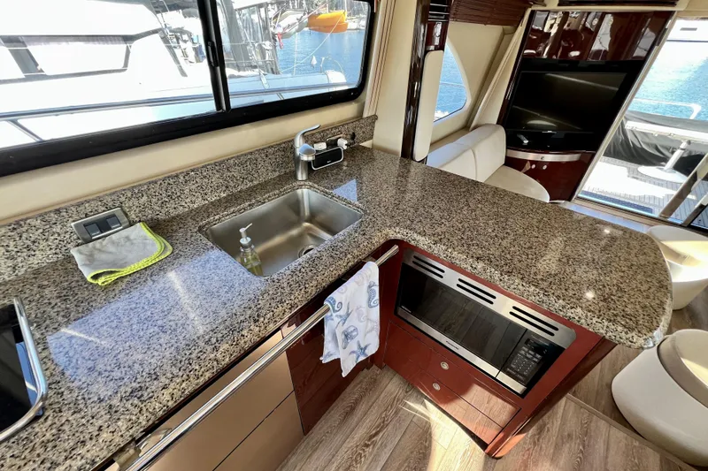 Slide: The Image of Luxurious kitchen interior of 2007 Sea Ray 58 Sedan Bridge yacht with granite countertops. - 90